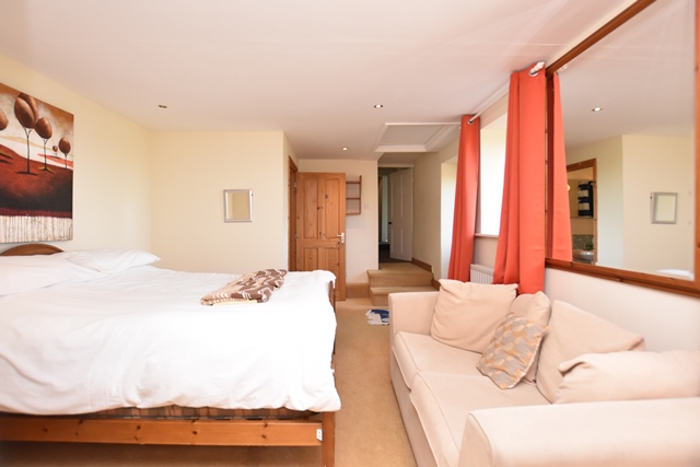 Bedroom 1: with kingsize bed and en-suite with shower cubicle and toilet. (Access to decked balcony).