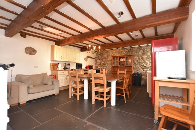 Kitchen/dining room: with electric cooker, microwave, fridge/freezer, dishwasher, beams and flagged floor.