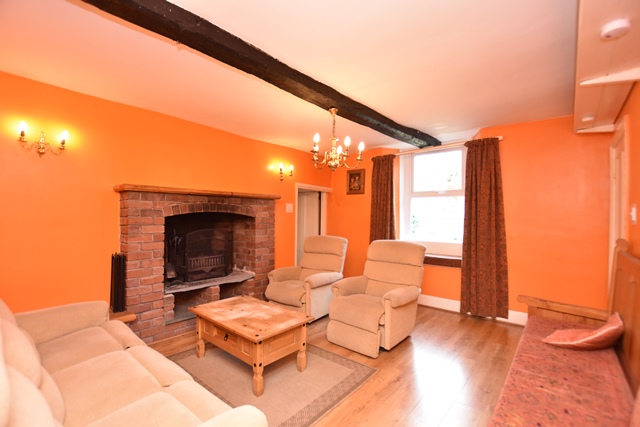Sitting room: with wood burner, beams and wooden floor.